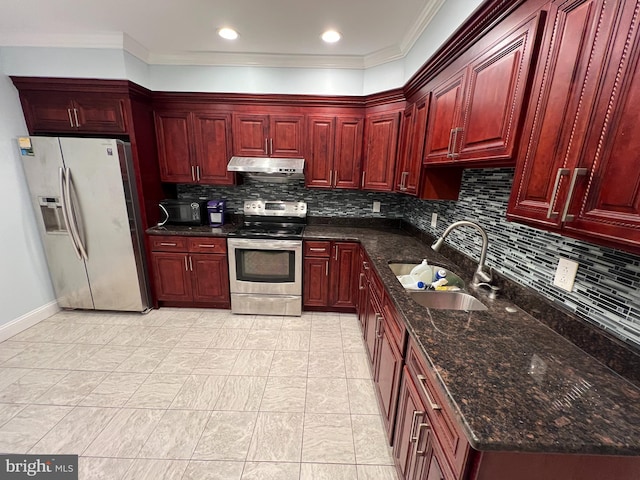 kitchen featuring sink, decorative backsplash, stainless steel appliances, dark stone counters, and ornamental molding