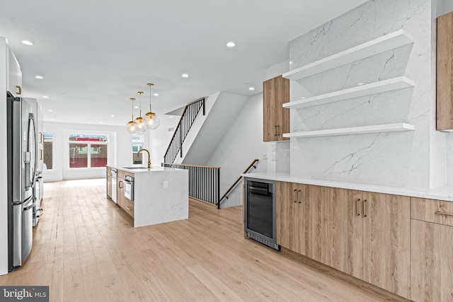 kitchen with open shelves, stainless steel appliances, light brown cabinetry, modern cabinets, and beverage cooler