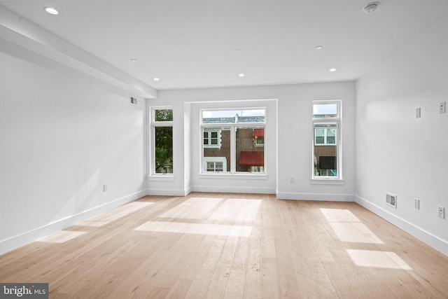 interior space featuring visible vents, baseboards, wood finished floors, and recessed lighting