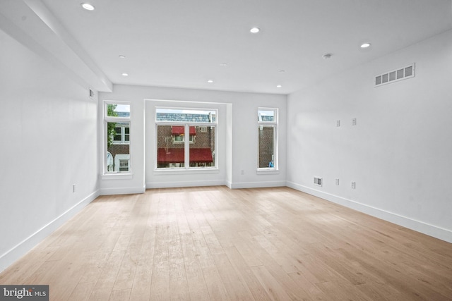 unfurnished living room with recessed lighting, visible vents, and light wood finished floors