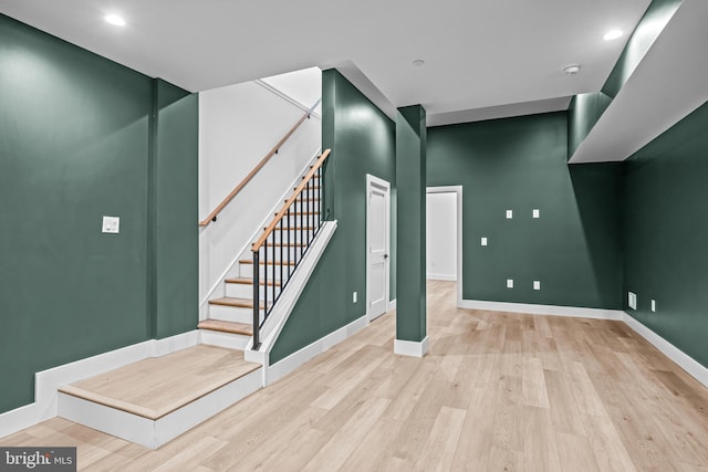 basement featuring stairway, recessed lighting, wood finished floors, and baseboards