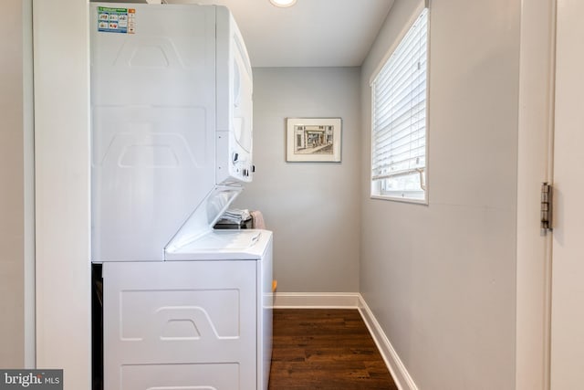 washroom with dark wood-type flooring and stacked washing maching and dryer