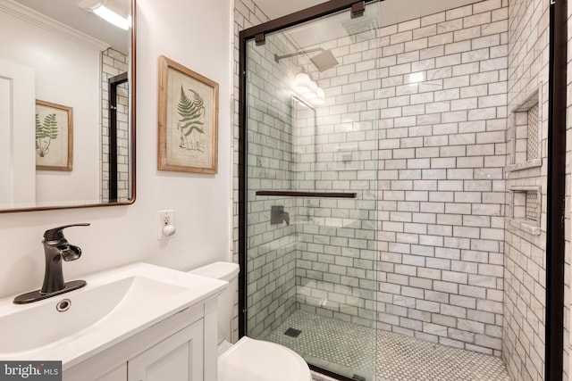 bathroom with vanity, toilet, an enclosed shower, and ornamental molding