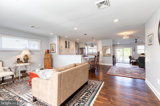 living room with ceiling fan and dark hardwood / wood-style floors