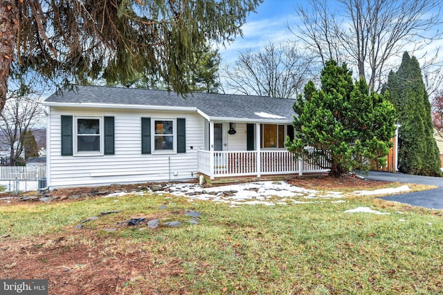 single story home with covered porch and a front lawn