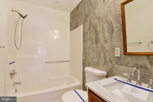 full bathroom with tasteful backsplash, bathtub / shower combination, tile walls, vanity, and toilet