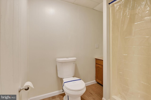 bathroom featuring hardwood / wood-style flooring, toilet, vanity, and walk in shower