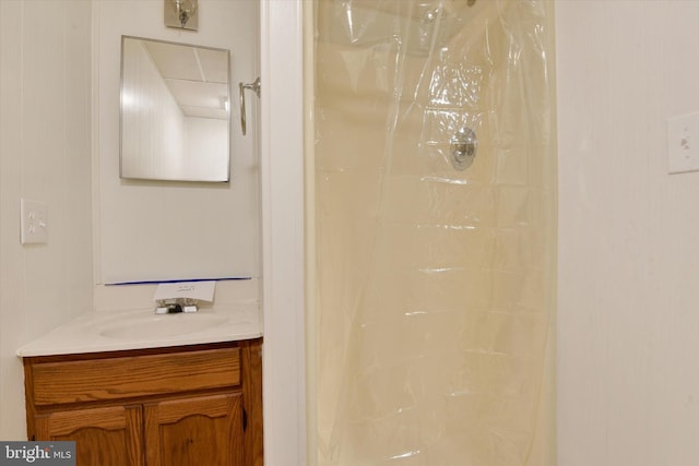 bathroom with vanity and a shower