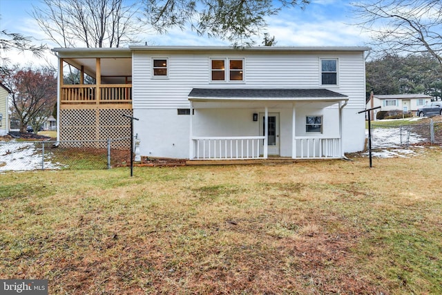 back of property with a porch and a lawn