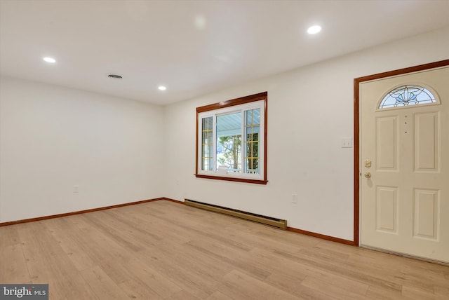 foyer entrance featuring a baseboard radiator and light wood-type flooring