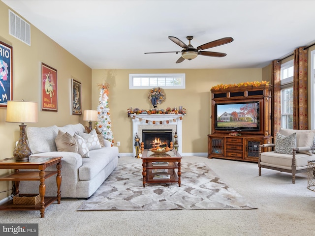 living room with ceiling fan, a healthy amount of sunlight, and carpet