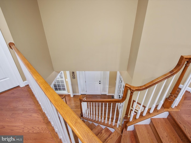 stairway with hardwood / wood-style flooring