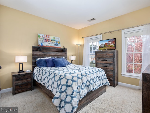 bedroom with light colored carpet