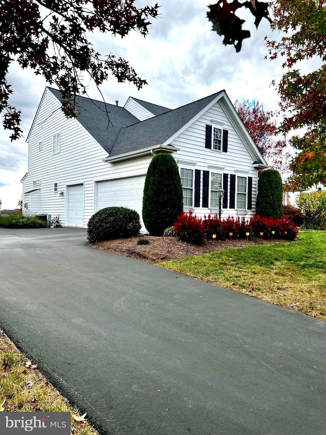 view of side of home featuring a garage