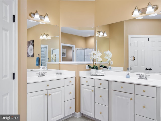 bathroom with vanity, an enclosed shower, and tile patterned floors