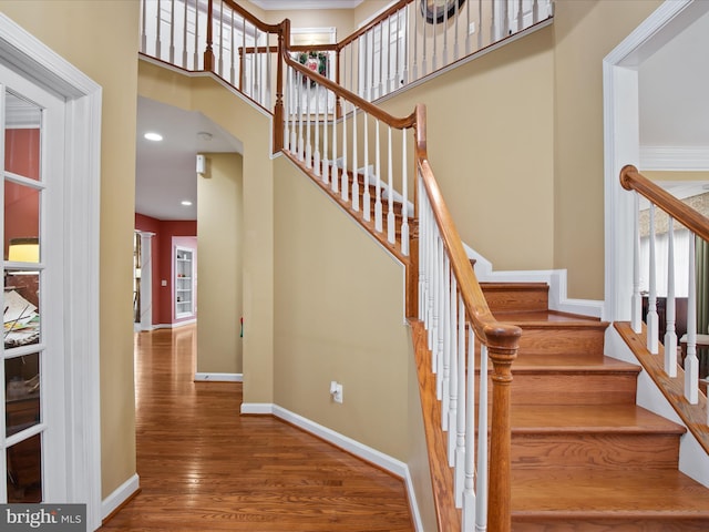 stairs with hardwood / wood-style floors