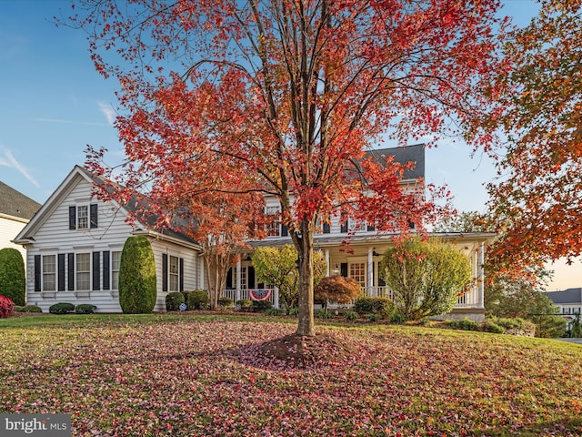 view of front of home with a porch and a yard