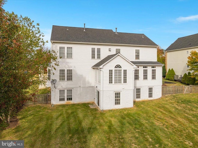 rear view of house with a lawn