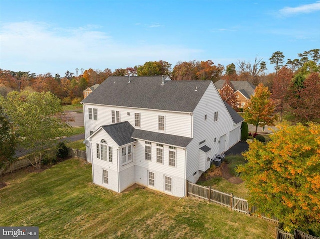 rear view of property featuring a lawn