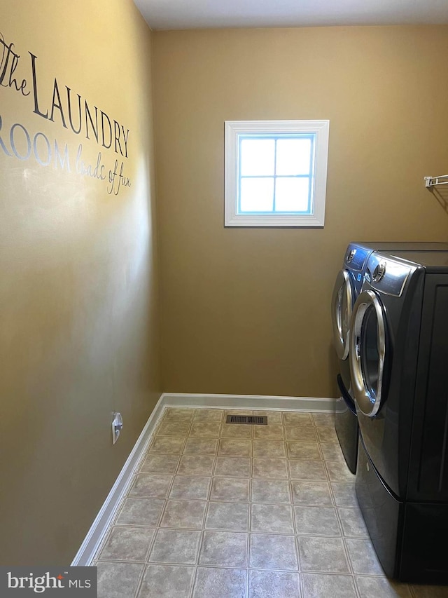 washroom featuring light tile patterned floors and washer and dryer