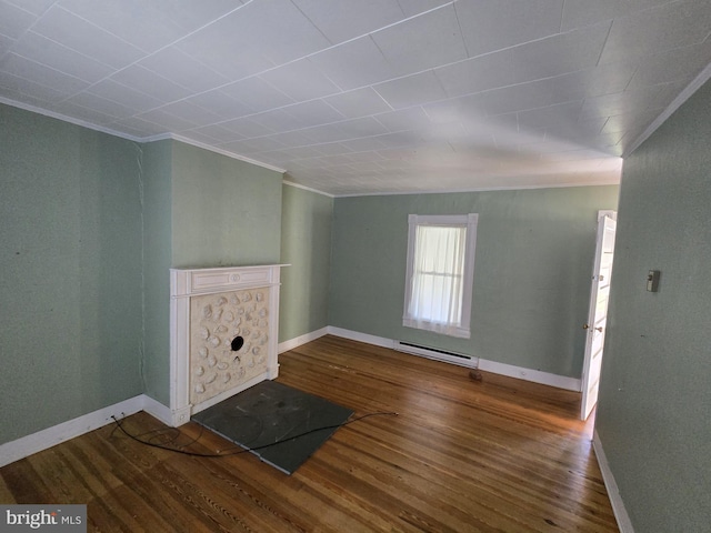 unfurnished living room featuring crown molding, hardwood / wood-style floors, and baseboard heating