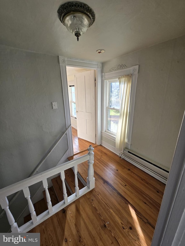 interior space featuring a baseboard radiator and hardwood / wood-style flooring