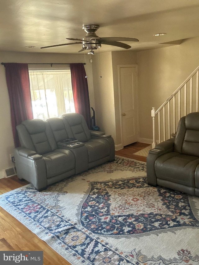 living room with hardwood / wood-style flooring and ceiling fan