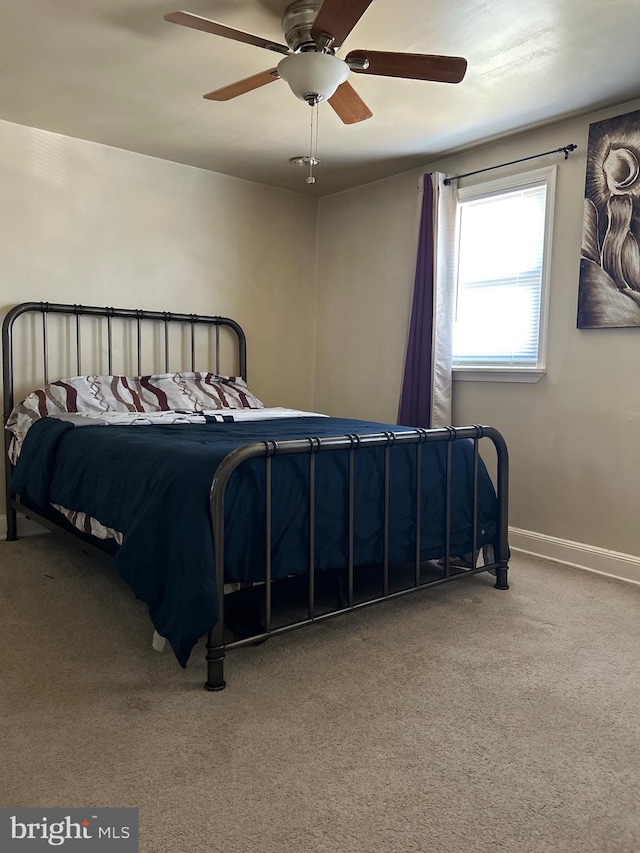 bedroom with ceiling fan and carpet flooring