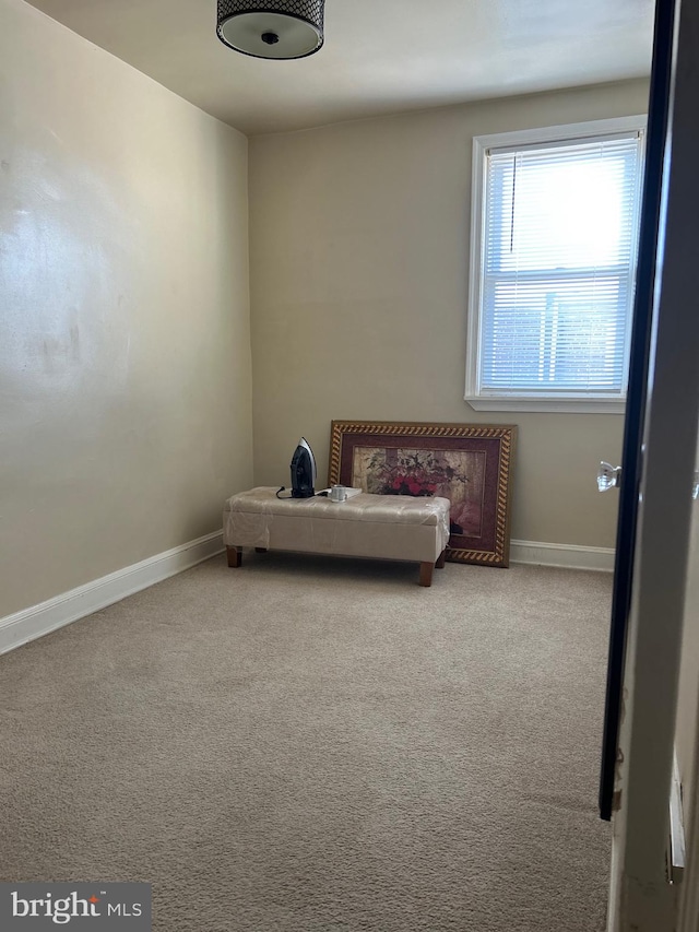 unfurnished room featuring light colored carpet