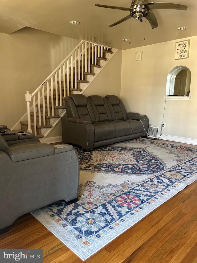 living room featuring hardwood / wood-style floors and ceiling fan