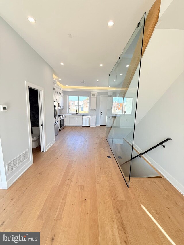 3011 Gaul St, Philadelphia, PA 19134 - unfurnished living room with light wood-style floors, recessed lighting, and baseboards