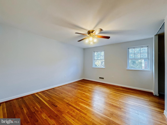 empty room featuring ceiling fan and light hardwood / wood-style flooring