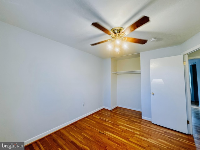 unfurnished bedroom featuring a closet, ceiling fan, and hardwood / wood-style flooring