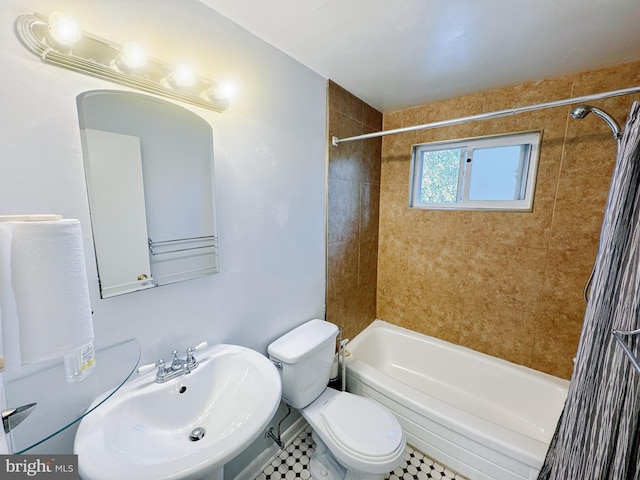 full bathroom featuring tile patterned flooring, toilet, sink, and tiled shower / bath