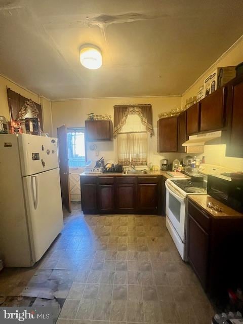 kitchen with dark brown cabinets and white appliances