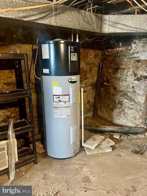 utility room featuring hybrid water heater