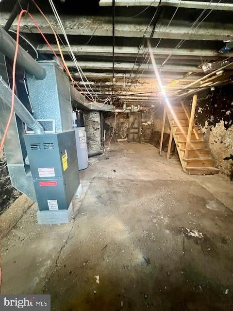 basement featuring water heater and heating unit