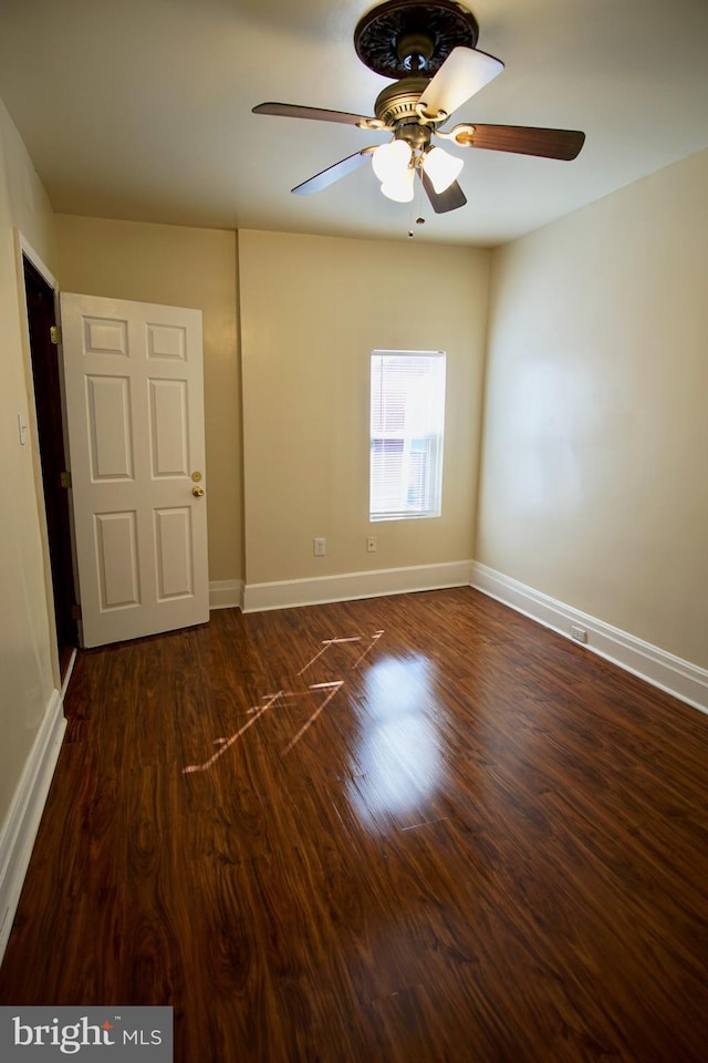 spare room featuring ceiling fan and dark hardwood / wood-style flooring