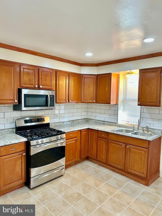 kitchen featuring decorative backsplash, light tile patterned flooring, sink, crown molding, and stainless steel appliances