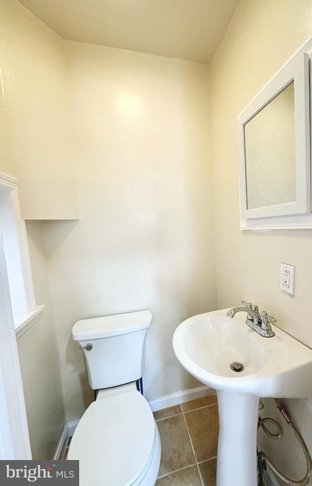 bathroom with tile patterned floors and toilet