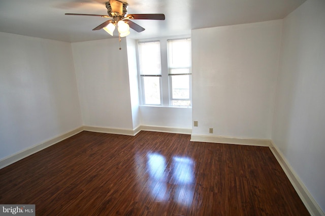 spare room featuring dark hardwood / wood-style floors and ceiling fan