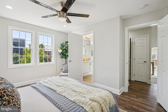 bedroom featuring dark wood-type flooring, ceiling fan, and ensuite bath