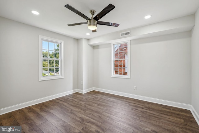 spare room with ceiling fan and dark hardwood / wood-style flooring