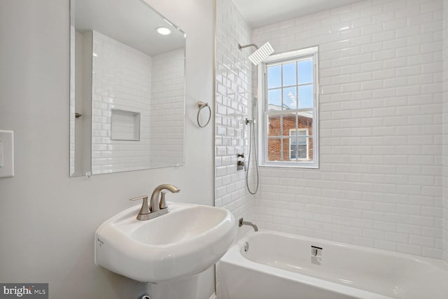 bathroom with sink and tiled shower / bath combo