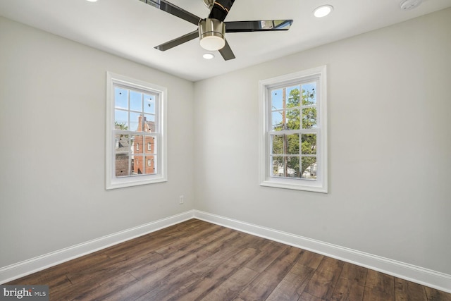 spare room with dark hardwood / wood-style floors and ceiling fan