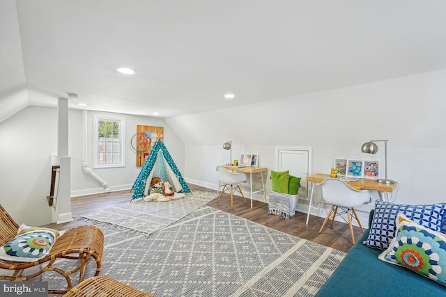 game room with lofted ceiling and dark hardwood / wood-style floors