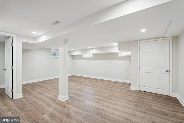 basement with light hardwood / wood-style flooring