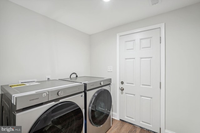 laundry room featuring dark hardwood / wood-style floors and separate washer and dryer