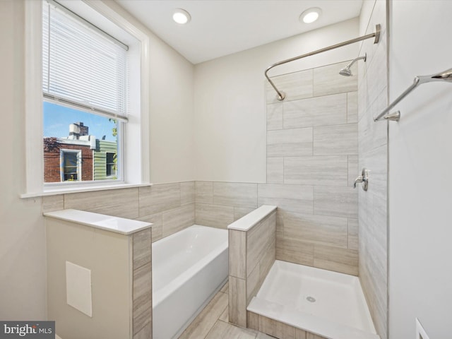 bathroom featuring separate shower and tub