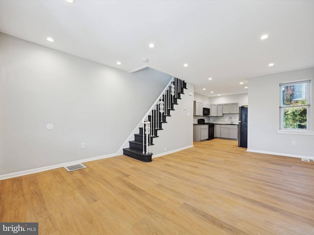 unfurnished living room with light hardwood / wood-style flooring